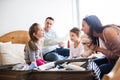 Young family with two children packing for holiday. Royalty Free Stock Photo