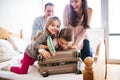 Young family with two children packing for holiday. Royalty Free Stock Photo