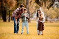 Young family with two children playing with soap bubbles Royalty Free Stock Photo