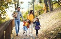 A young family with children walking in park in autumn. Royalty Free Stock Photo