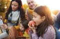 A young family with two small children having picnic in autumn nature at sunset. Royalty Free Stock Photo