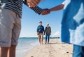 Young family with two small children outdoors on beach. Royalty Free Stock Photo