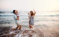 A young family with two toddler children having fun on beach on summer holiday. Royalty Free Stock Photo