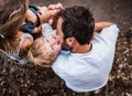 A young family with two toddler children outdoors by the river in summer, top view. Royalty Free Stock Photo