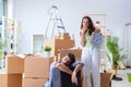 The young family unpacking at new house with boxes