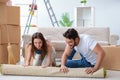 The young family unpacking at new house with boxes Royalty Free Stock Photo