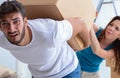 Young family unpacking at new house with boxes Royalty Free Stock Photo