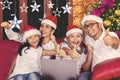 Young family using a laptop at Christmas time Royalty Free Stock Photo