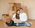 Young family using laptop in their new home Royalty Free Stock Photo