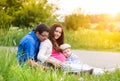 Young family on a walk in green sunny summer nature Royalty Free Stock Photo