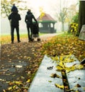 Young Family Walking Through Harrow Parkin in Autumn