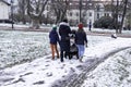 Young Family walking in park in first winter snow, The Czech Republic