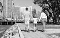 young family walking in park with son back view, parents