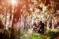 Young family in warm clothes cycling in autumn park Royalty Free Stock Photo