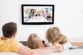 Young family watching tv together Royalty Free Stock Photo