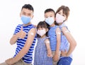 Young Family Wearing Face Masks Showing Adhesive Bandage After Coronavirus Vaccination