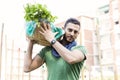 Young farmer carrying a basket of vegetables in his garden Royalty Free Stock Photo
