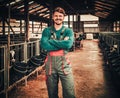 Young farmer in a cowshed on a dairy farm