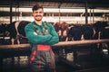 Young farmer in a cowshed on a dairy farm