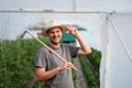 Young farmer in front of small greenhouse. Small business entrepreneur. Royalty Free Stock Photo