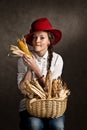 Young farmer girl with a corncob