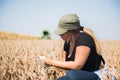 Young farmer girl examing soybean plant during harvest Royalty Free Stock Photo