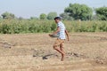 A young farmer giving manure to the crop grown in the field