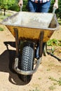 Young farmer man pushing a wheelbarrow Royalty Free Stock Photo