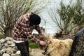 Young farmer playing with his dog in a garage Royalty Free Stock Photo