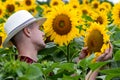 Farmer standing in sunflower field and examining the crop. Royalty Free Stock Photo