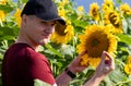 Farmer standing in sunflower field examining the crop. Royalty Free Stock Photo