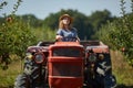 Young farmer woman driving her old tractor Royalty Free Stock Photo