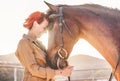 Young farmer woman hugging her horse - Cowgirl having fun inside equestrian corral ranch - Concept about love between people and Royalty Free Stock Photo