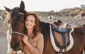 Young farmer woman playing with her horse at farm ranch - Focus on female face Royalty Free Stock Photo