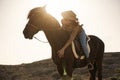 Young farmer woman riding her horse in a sunny day outdoor - Focus on face Royalty Free Stock Photo