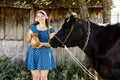 Young farmer woman smiling on camera carries jug of milk after milking cow on farm pasture. an milking the cows. Royalty Free Stock Photo