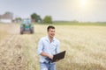 Young farmer yelling in the field