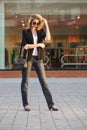 Young fashion blond business woman in black blazer and sunglasses