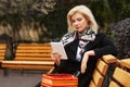 Young fashion blond business woman using digital tablet computer on the bench Royalty Free Stock Photo