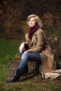 Young fashion blond woman in autumn forest Royalty Free Stock Photo