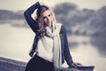 Young fashion blond woman in denim jacket and scarf Royalty Free Stock Photo