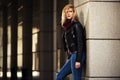 Young fashion blond woman in leather jacket at the wall Royalty Free Stock Photo
