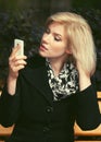 Young fashion blonde business woman using cell phone on city street Royalty Free Stock Photo