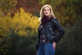 Young fashion blonde woman in black leather jacket and snood scarf Royalty Free Stock Photo