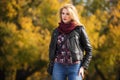 Young fashion blonde woman in black leather jacket and snood scarf