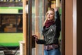 Young fashion blonde woman in leather jacket and snood scarf