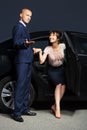 Young fashion business couple at the car in night