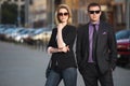 Young fashion business couple walking on city street Royalty Free Stock Photo