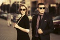 Young fashion business couple walking on city street Royalty Free Stock Photo