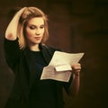 Young fashion business woman in black blazer reading tax letter Royalty Free Stock Photo